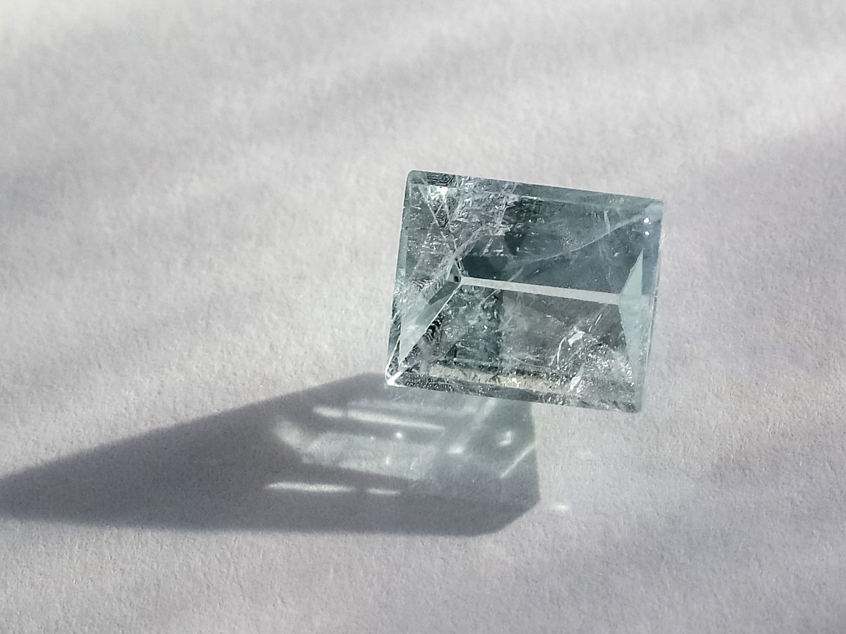 Macro photograph of a faceted transparent stone lit from the side — sample photo